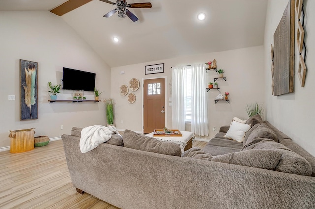 living room featuring ceiling fan, hardwood / wood-style floors, and vaulted ceiling