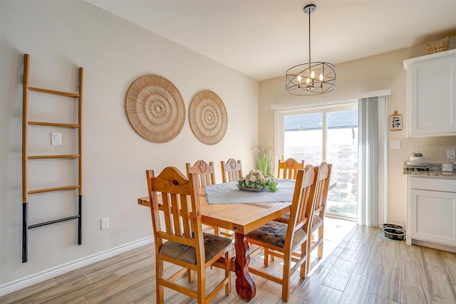 dining room featuring an inviting chandelier and light hardwood / wood-style flooring