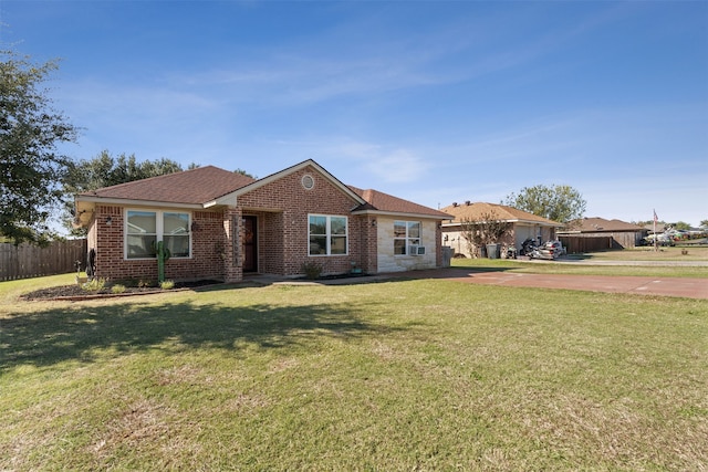 ranch-style home with a front lawn