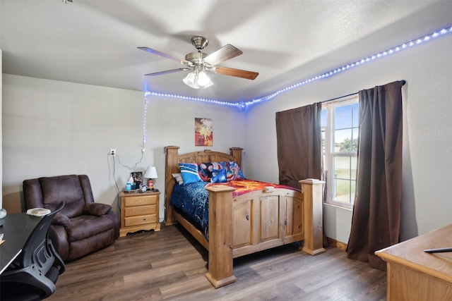 bedroom featuring ceiling fan and dark hardwood / wood-style flooring