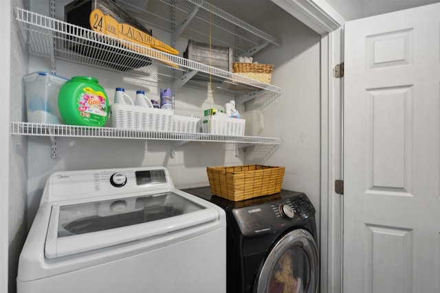 clothes washing area featuring independent washer and dryer