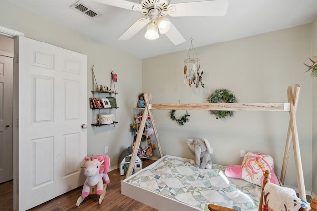 bedroom featuring dark hardwood / wood-style flooring and ceiling fan