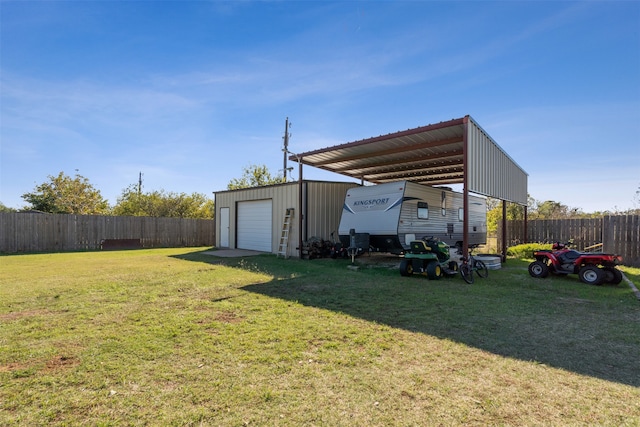 view of yard featuring a carport, a garage, and an outdoor structure