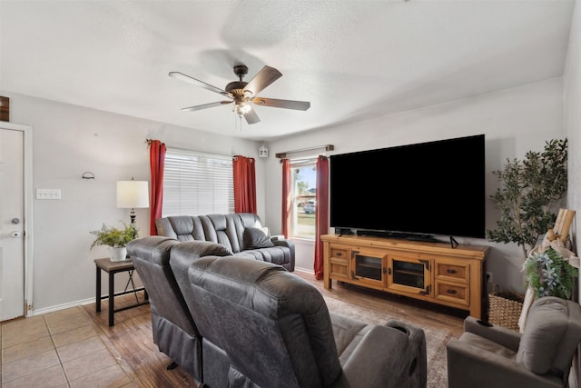 living room featuring a textured ceiling and ceiling fan