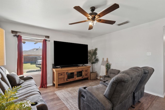 living room with hardwood / wood-style floors and ceiling fan