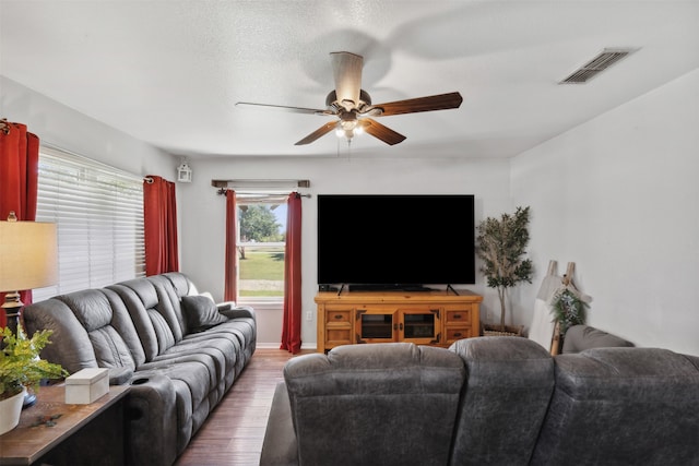 living room featuring hardwood / wood-style floors and ceiling fan