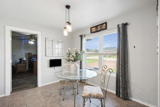 tiled dining area with ceiling fan