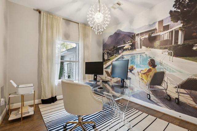 interior space featuring an inviting chandelier and hardwood / wood-style flooring