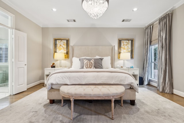 bedroom with wood-type flooring, crown molding, and an inviting chandelier