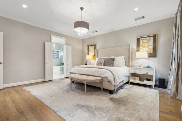 bedroom featuring a chandelier, connected bathroom, wood-type flooring, and ornamental molding