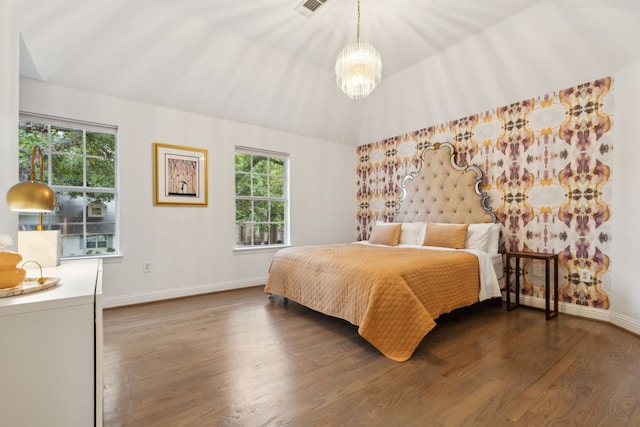 bedroom with a chandelier, lofted ceiling, dark hardwood / wood-style floors, and multiple windows