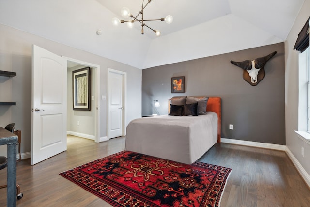 bedroom featuring a raised ceiling, lofted ceiling, a chandelier, and hardwood / wood-style flooring