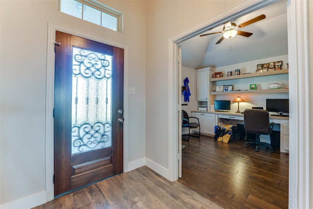 foyer with built in desk, dark hardwood / wood-style floors, ceiling fan, and vaulted ceiling