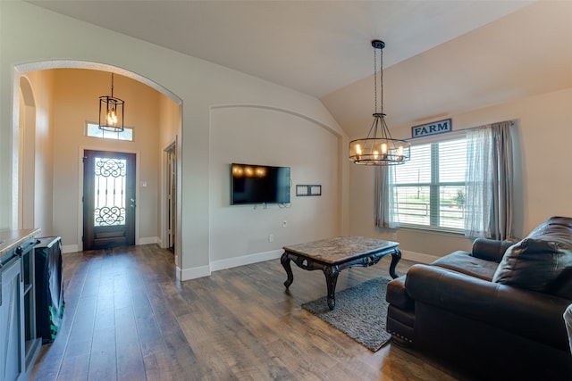 living room with dark hardwood / wood-style flooring and vaulted ceiling