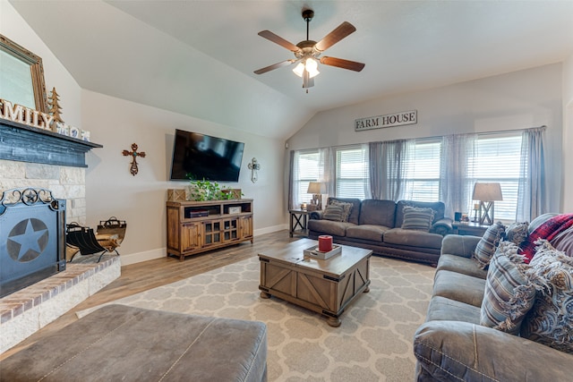 living room with light hardwood / wood-style flooring, a wealth of natural light, lofted ceiling, and ceiling fan