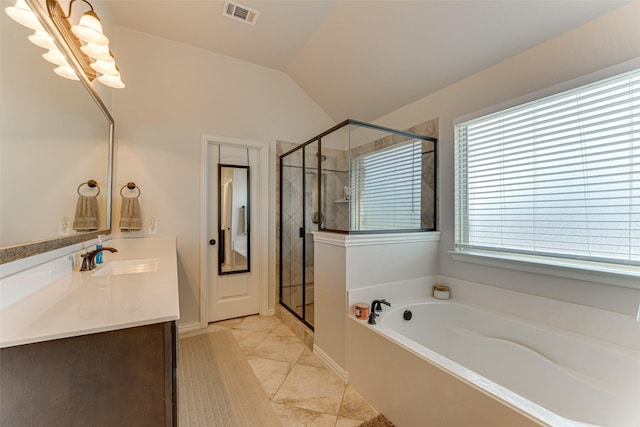 bathroom featuring tile patterned floors, vanity, separate shower and tub, and vaulted ceiling