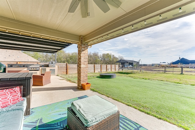 view of patio / terrace with a grill and a trampoline