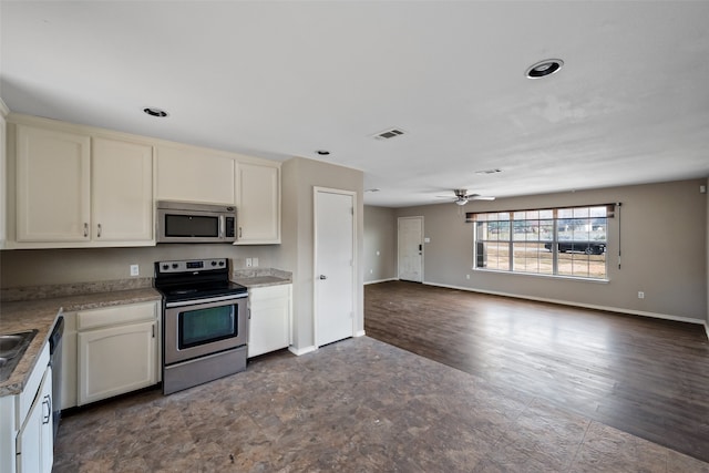 kitchen featuring ceiling fan, white cabinetry, stainless steel appliances, and dark wood-type flooring