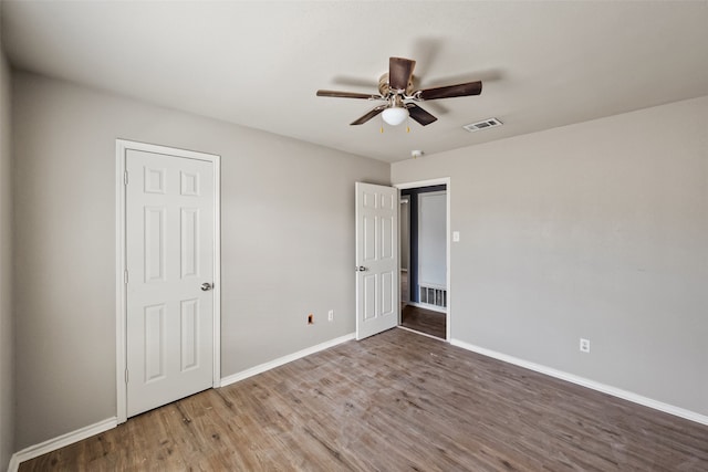 unfurnished bedroom with hardwood / wood-style floors and ceiling fan