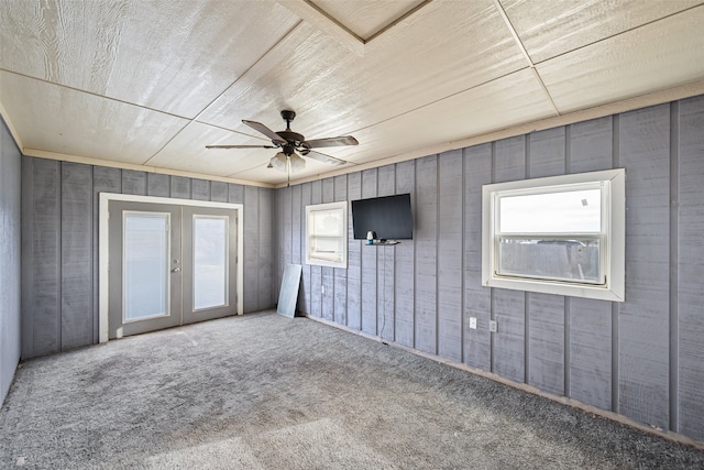 unfurnished bedroom with carpet flooring, ceiling fan, and french doors