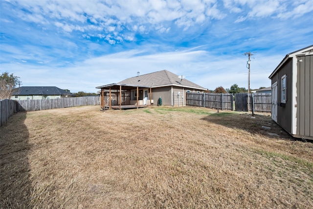 view of yard with a storage unit and a wooden deck