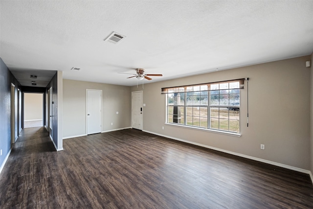 spare room with a textured ceiling, ceiling fan, and dark hardwood / wood-style floors