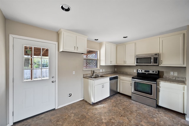 kitchen featuring white cabinets, stainless steel appliances, and sink