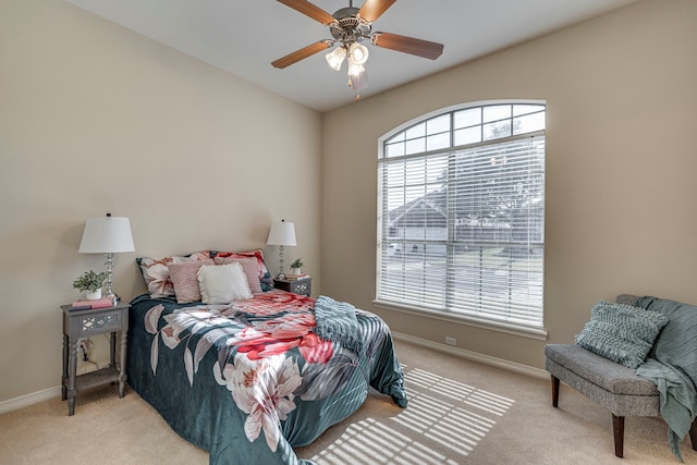 bedroom featuring ceiling fan and light carpet