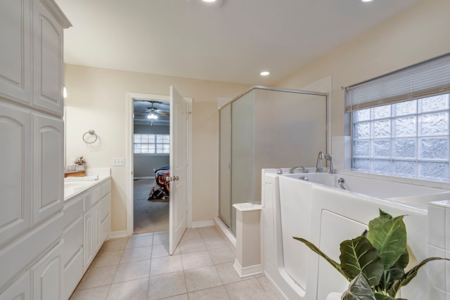 bathroom with tile patterned floors, vanity, ceiling fan, and an enclosed shower