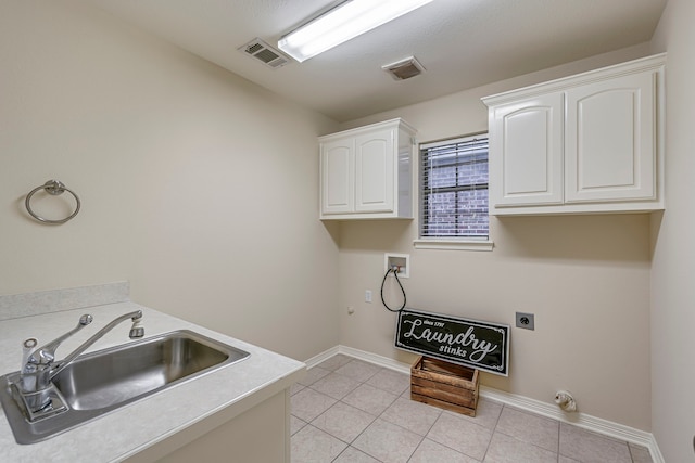 clothes washing area featuring sink, cabinets, washer hookup, electric dryer hookup, and light tile patterned floors