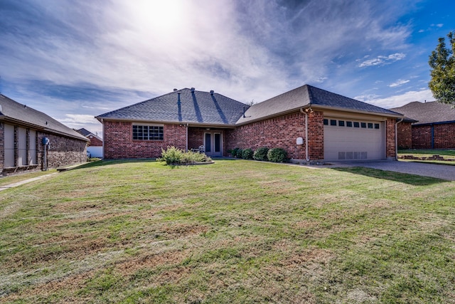 single story home with a garage and a front yard