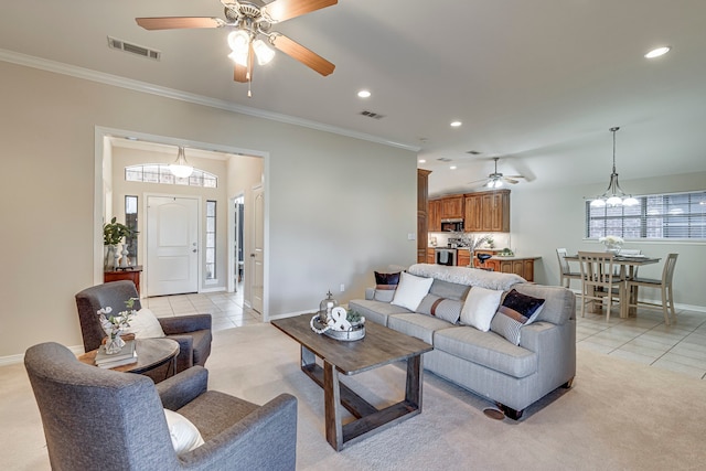 tiled living room with ceiling fan with notable chandelier and crown molding