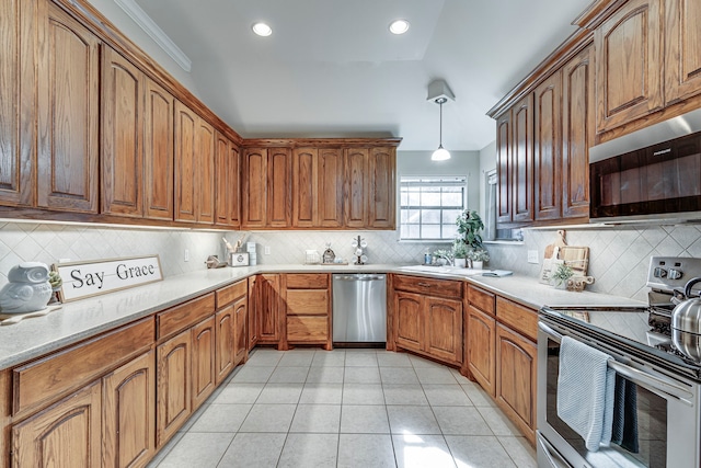 kitchen with sink, hanging light fixtures, tasteful backsplash, light tile patterned flooring, and stainless steel appliances