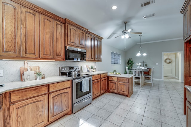 kitchen with backsplash, vaulted ceiling, light tile patterned floors, decorative light fixtures, and stainless steel appliances