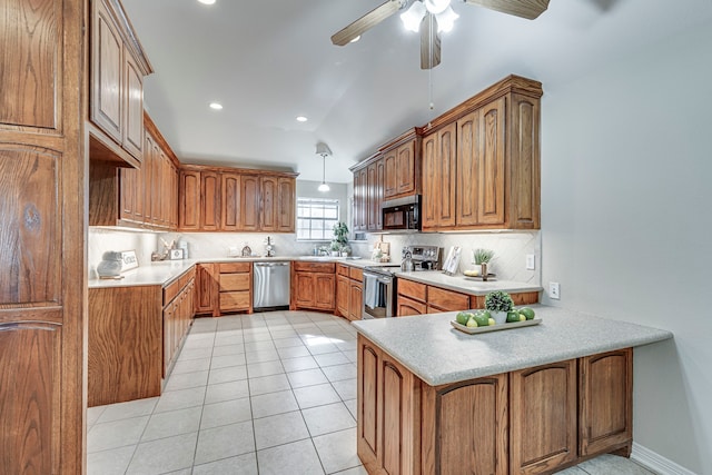 kitchen with ceiling fan, tasteful backsplash, kitchen peninsula, pendant lighting, and appliances with stainless steel finishes