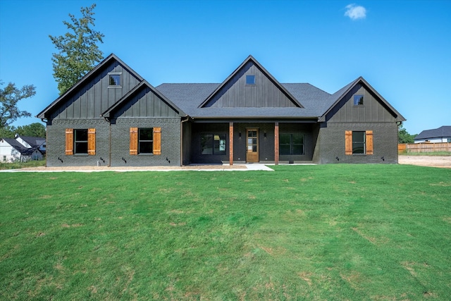 rear view of property with a lawn