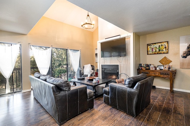 living room featuring dark hardwood / wood-style flooring, vaulted ceiling, and a wealth of natural light