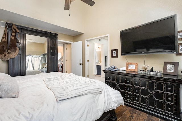 bedroom with ceiling fan, dark hardwood / wood-style flooring, and ensuite bathroom