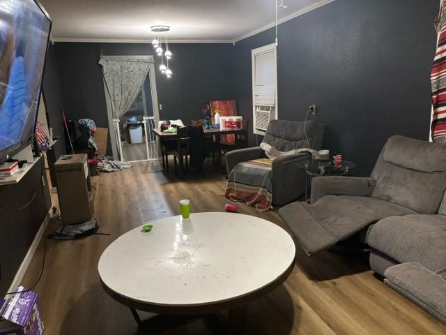 interior space featuring hardwood / wood-style flooring and ornamental molding