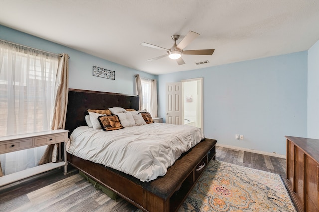 bedroom with ceiling fan and dark wood-type flooring