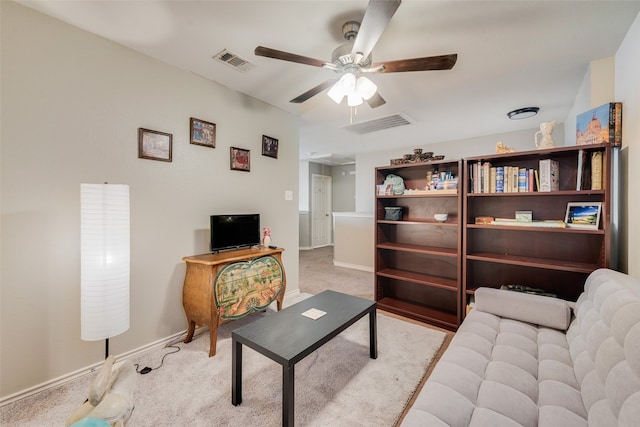 carpeted living room featuring ceiling fan