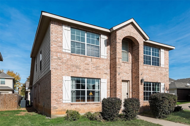 view of front of property featuring central AC and a front lawn