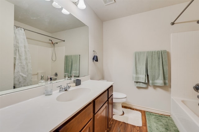 bathroom with hardwood / wood-style flooring, vanity, and toilet