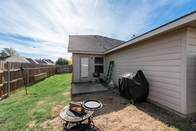 back of house with a lawn and a patio area