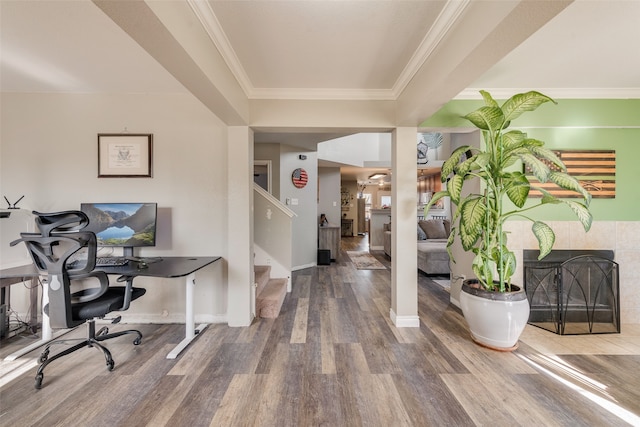 foyer entrance featuring hardwood / wood-style flooring, crown molding, and a tiled fireplace