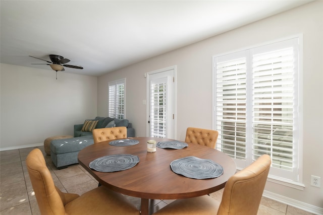 dining room featuring ceiling fan, a healthy amount of sunlight, and light tile patterned flooring