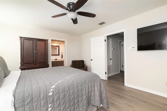 bedroom featuring connected bathroom, ceiling fan, and light hardwood / wood-style flooring