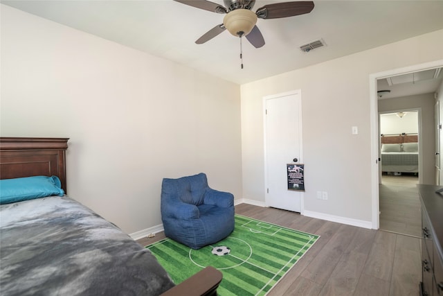 bedroom featuring ceiling fan and dark wood-type flooring