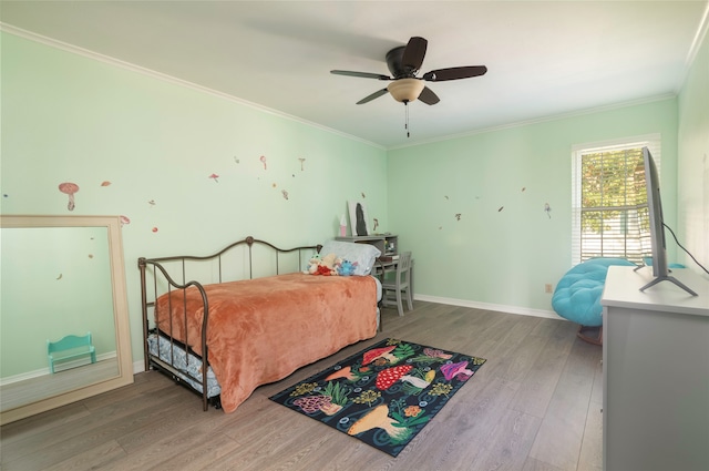 bedroom with ceiling fan, crown molding, and hardwood / wood-style flooring