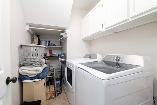 washroom with washer and dryer, light tile patterned flooring, and cabinets